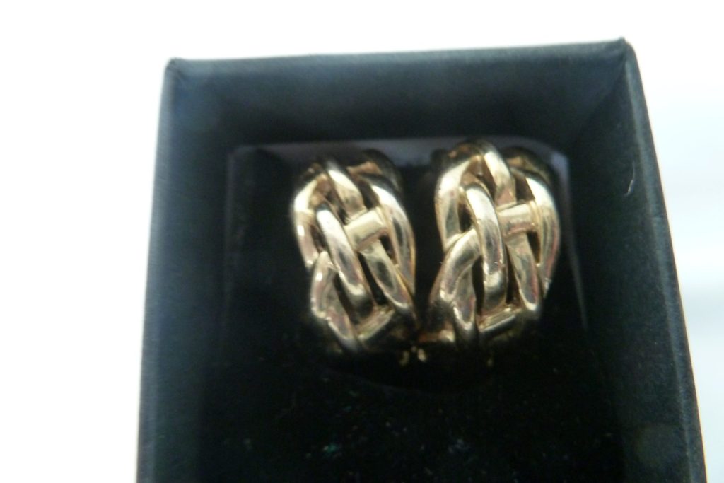 Pair of vintage chunky gold-tone Celtic knot clip-on earrings in a black jewellery box